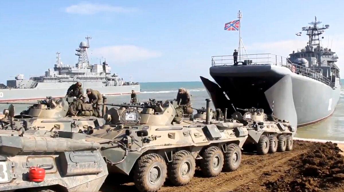 This handout photo taken from a video released by Russian Defense Ministry Press Service shows, Russian military's armored vehicles roll into landing vessels after drills in Crimea on Friday, April 23, 2021. (Russian Defense Ministry Press Service via AP)