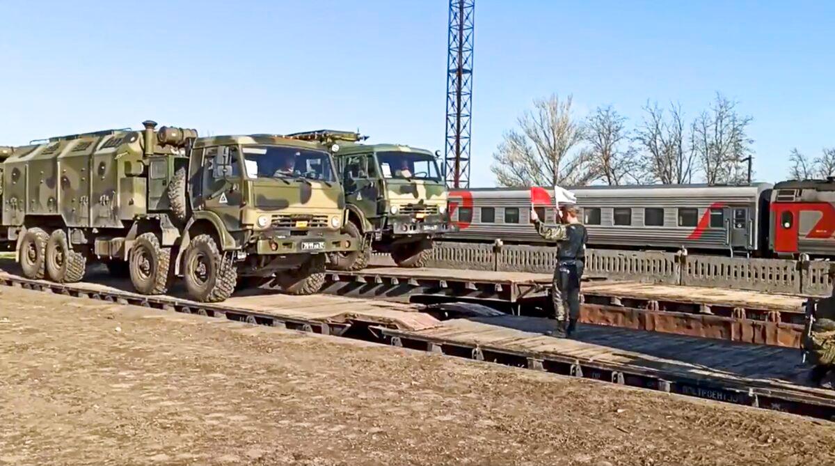 This handout photo taken from a video released by Russian Defense Ministry Press Service shows Russian military trucks are readied for loading after drills in Crimea on Friday, April 23, 2021. (Russian Defense Ministry Press Service via AP)