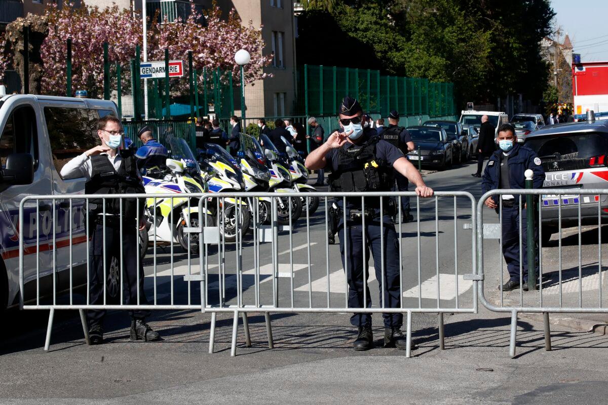 A police officer blocks the access next to the Police station in Rambouillet, south west of Paris, on April 23, 2021. (Michel Euler/AP Photo)
