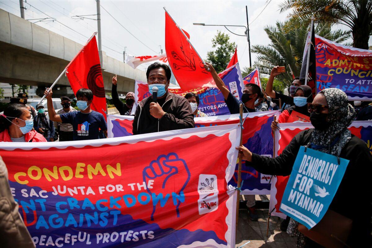 Activists hold placards and banners during a protest to support the anti-coup movement and democracy in Burma, near the Association of Southeast Asian Nations (ASEAN) secretariat building, ahead of the ASEAN leaders' meeting in Jakarta, Indonesia April 24, 2021. (Willy Kurniawan/Reuters)