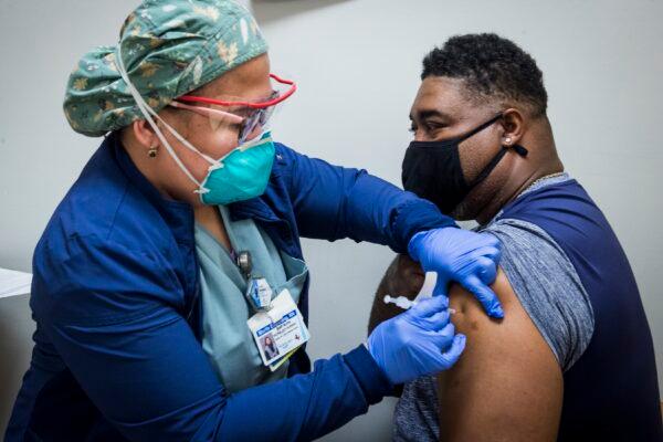 A nurse administers a COVID-19 vaccine to a man in Houston, Texas, on Feb. 11, 2021. (Brett Coomer/Houston Chronicle via AP)