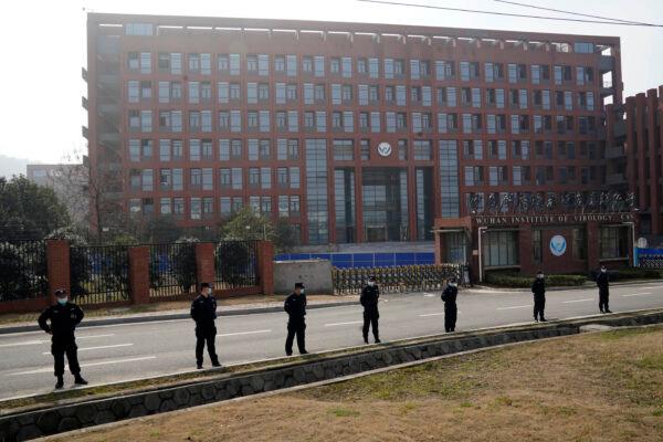 Security personnel gather near the entrance to the Wuhan Institute of Virology during a visit by the World Health Organization team in Wuhan, China, on Feb. 3, 2021. (Ng Han Guan/AP Photo)