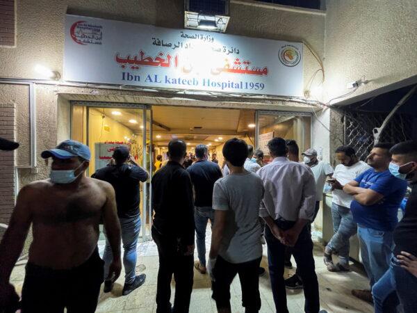 People gather at Ibn Khatib hospital after a fire caused by an oxygen tank explosion in Baghdad, Iraq, on April 25, 2021. (Thaier Al-Sudani/Reuters)