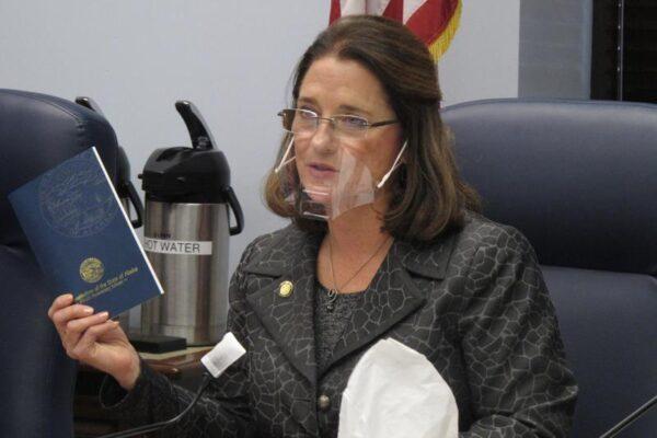 Alaska state Sen. Lora Reinbold, an Eagle River Republican, holds a copy of the Alaska Constitution during a committee hearing in Juneau, Alaska on Jan. 27, 2021 (Becky Bohrer/AP Photo)