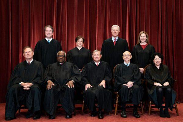 Seated from left: Associate Justice Samuel Alito, Associate Justice Clarence Thomas, Chief Justice John Roberts, Associate Justice Stephen Breyer, and Associate Justice Sonia Sotomayor, standing from left: Associate Justice Brett Kavanaugh, Associate Justice Elena Kagan, Associate Justice Neil Gorsuch, and Associate Justice Amy Coney Barrett pose during a group photo of the Justices at the Supreme Court in Washington, on April 23, 2021. (Erin Schaff/Pool/AFP via Getty Images)