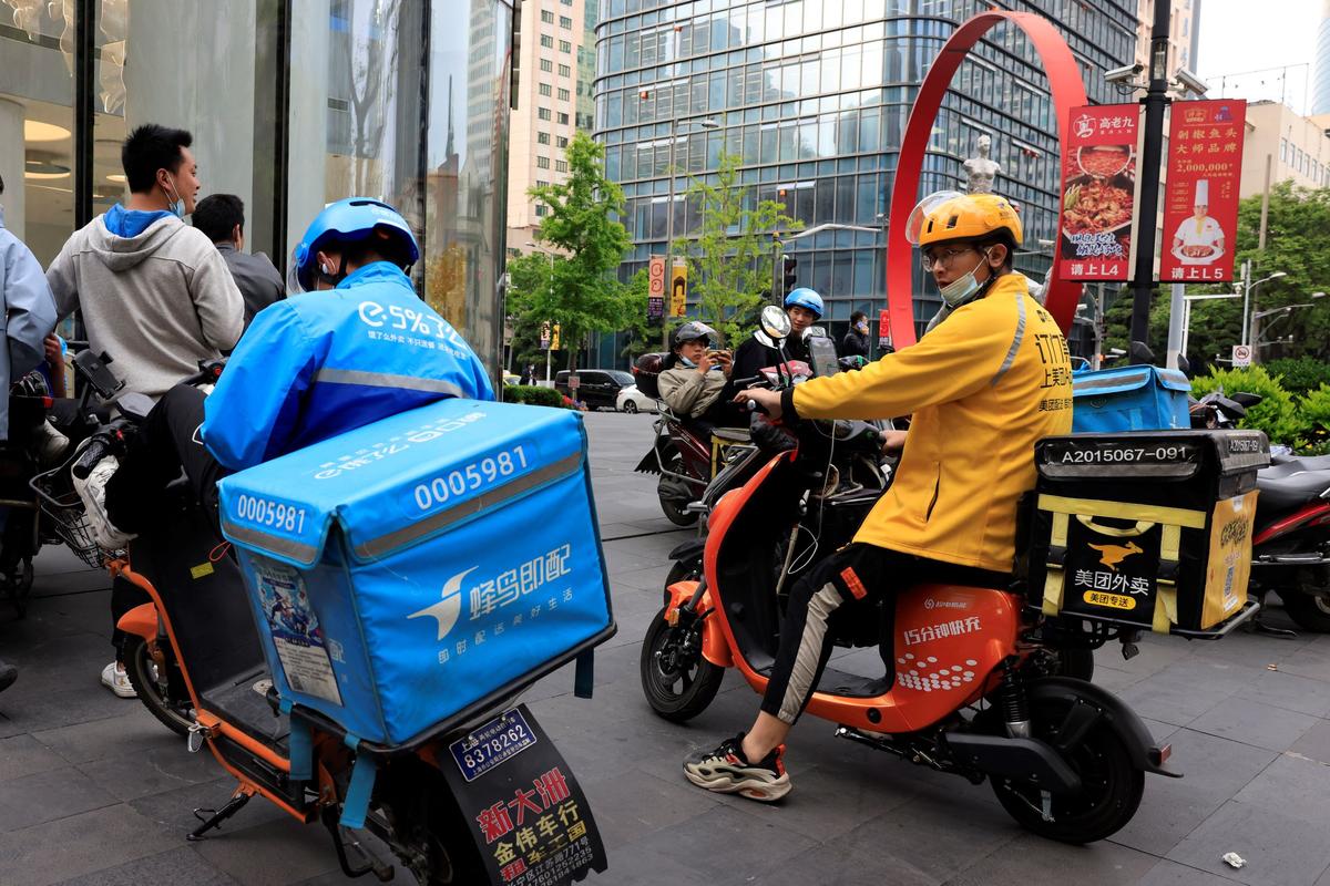 A Meituan delivery man in yellow goes on his rounds in Shanghai, on April 21, 2021. (Ng Han Guan/AP Photo)