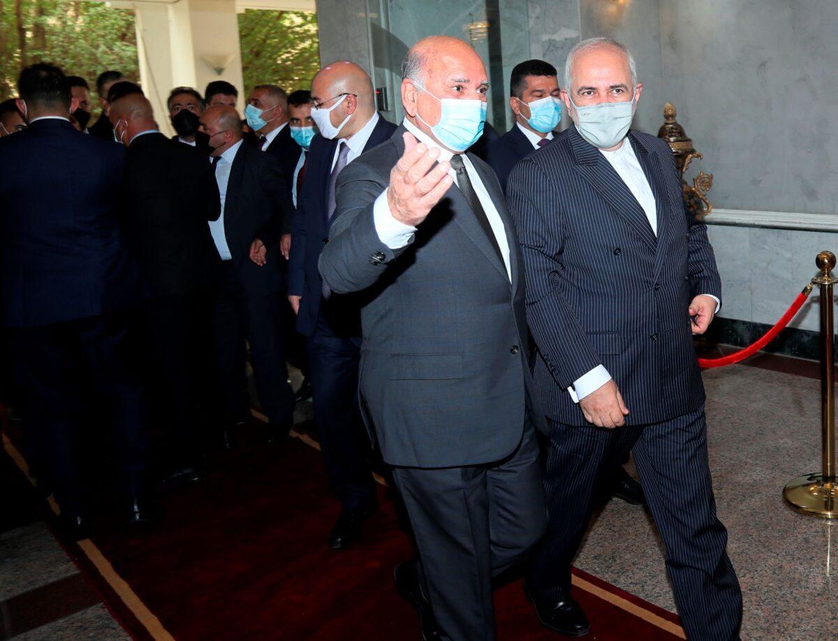 Iranian Foreign Minister Mohammad Javad Zarif (R) arrives to meet his Iraqi counterpart Fouad Hussein (C) in Baghdad, Iraq, on April 26, 2021. (Khalid Mohammed/AP Photo)