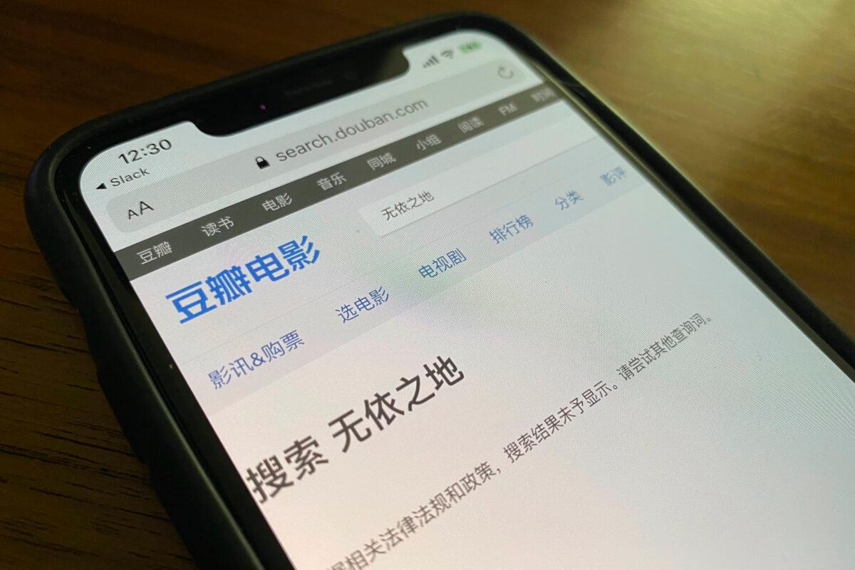 A phone shows a search page from Douban for Nomadland resulting in the message "the search results could not be displayed in accordance to relevant laws and regulations." in Beijing, China, on April 26, 2021. (Ng Han Guan/AP Photo)