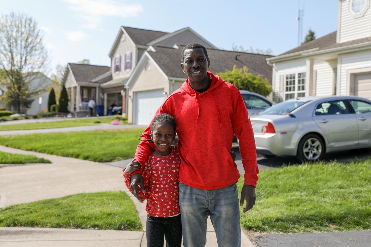 Ousmana Sy and his daughter on Legion Lane, close to where a police officer shot Ma'Khia Bryant, a 16-year-old girl, who was attacking a woman with a knife, in Columbus, Ohio, on April 23, 2021. (Samira Bouaou/The Epoch Times)