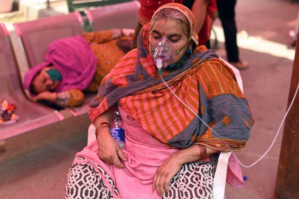 A patient breathes with the help of oxygen provided by a Gurdwara, a place of worship for Sikhs, under a tent installed along the roadside amid the COVID-19 coronavirus pandemic in Ghaziabad, India, on April 26, 2021. (Sajjad Hussain/Getty Images)