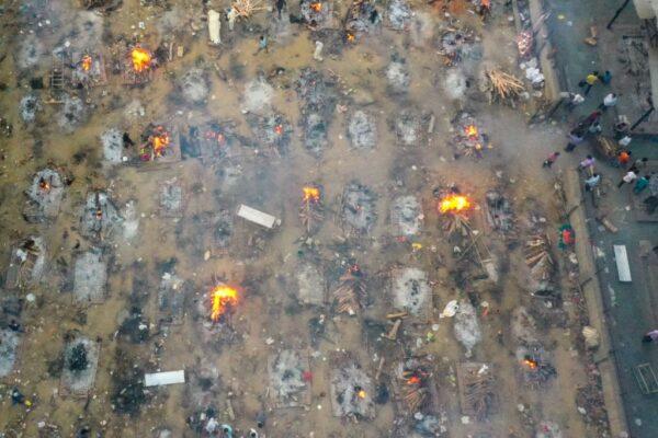 In this aerial picture taken on April 26, 2021, burning pyres of victims who lost their lives due to the Covid-19 coronavirus are seen at a cremation ground in New Delhi. (Jewel Samad/Getty Images)