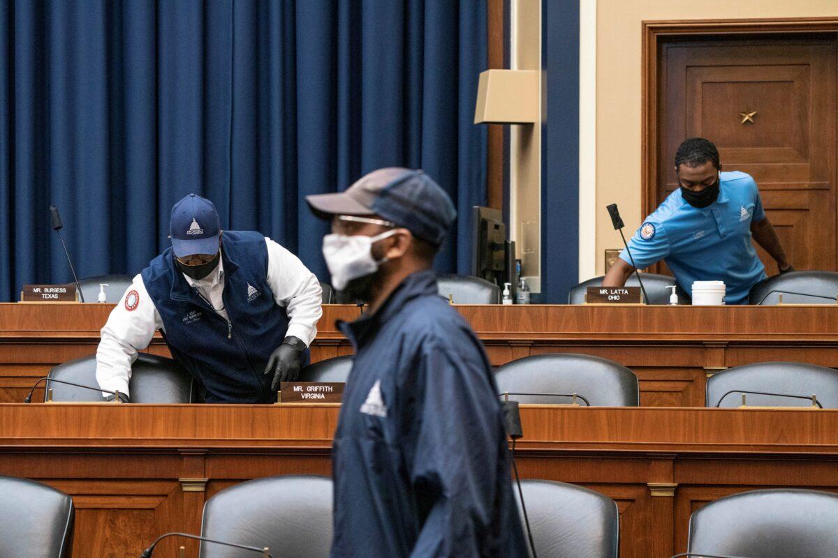 U.S. Capitol maintenance staff disinfect surfaces before the House Energy and Commerce Committee hearing on coronavirus in Washington on June 23, 2020. (Sarah Silbiger/Pool via Reuters)