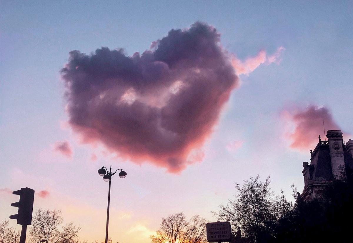 An incredible heart-shaped cloud hovering above the most romantic city in the world. (SWNS)