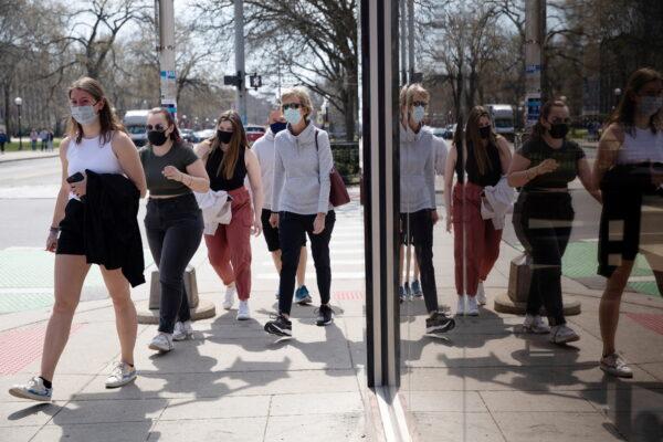 A group of people walk wearing masks in Ann Arbor, Mich., on April 4, 2021. (Emily Elconin/Reuters)