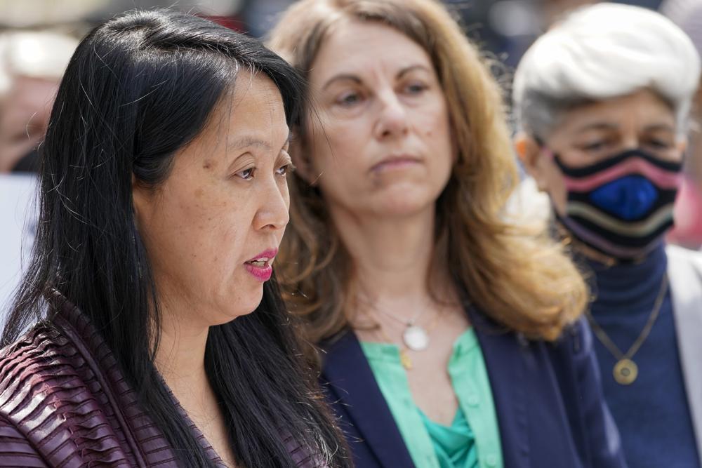 Jean Kim, left, is joined by her attorney Patricia Pastor, center, as she speaks to reporters during a news conference in New York on April 28, 2021. (Mary Altaffer/AP Photo)