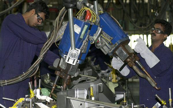Employees of Ford India Private Limited work in a factory of the company in Chengalpattu, India, on July 9, 2003. (Dibyangshu Sarkar/AFP via Getty Images)