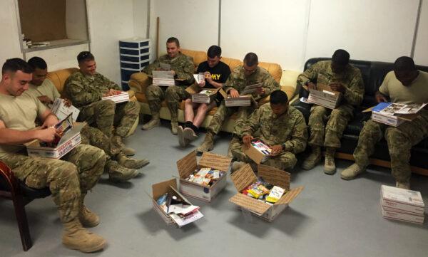 U.S. soldiers serving overseas show off new boots sent in care packages from Helping Soldiers in the Desert, an organization founded by former Marine Si Tenenberg. (Courtesy of Si Tenenberg)