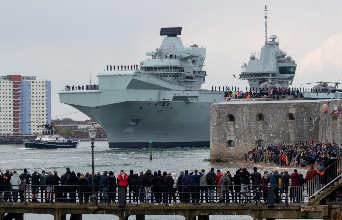The Royal Navy aircraft carrier HMS Queen Elizabeth passes the Round Tower as it leaves Portsmouth Naval Base in Hampshire for exercises off Scotland before heading to the Indo-Pacific region, on May 1, 2021. (PA)
