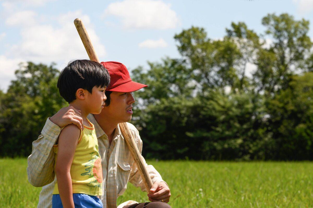 Son David (Alan S. Kim, L) and his father, Jacob (Steven Yeun), figure out the best place to dig a well in “Minari.” (A24)