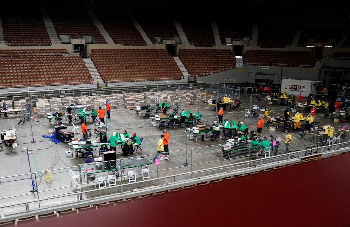 A general view of Veterans Memorial Coliseum shows ballots being reviewed during an audit of the 2020 election, in Phoenix, Ariz., on April 29, 2021. (Rob Schumacher/The Arizona Republic via AP/Pool)