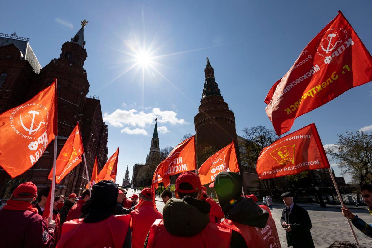  Communist party supporters gather with red flags to mark Labour Day, also known as May Day near Red Square in Moscow, Russia, on May 1, 2021. (Alexander Zemlianichenko/AP Photo)