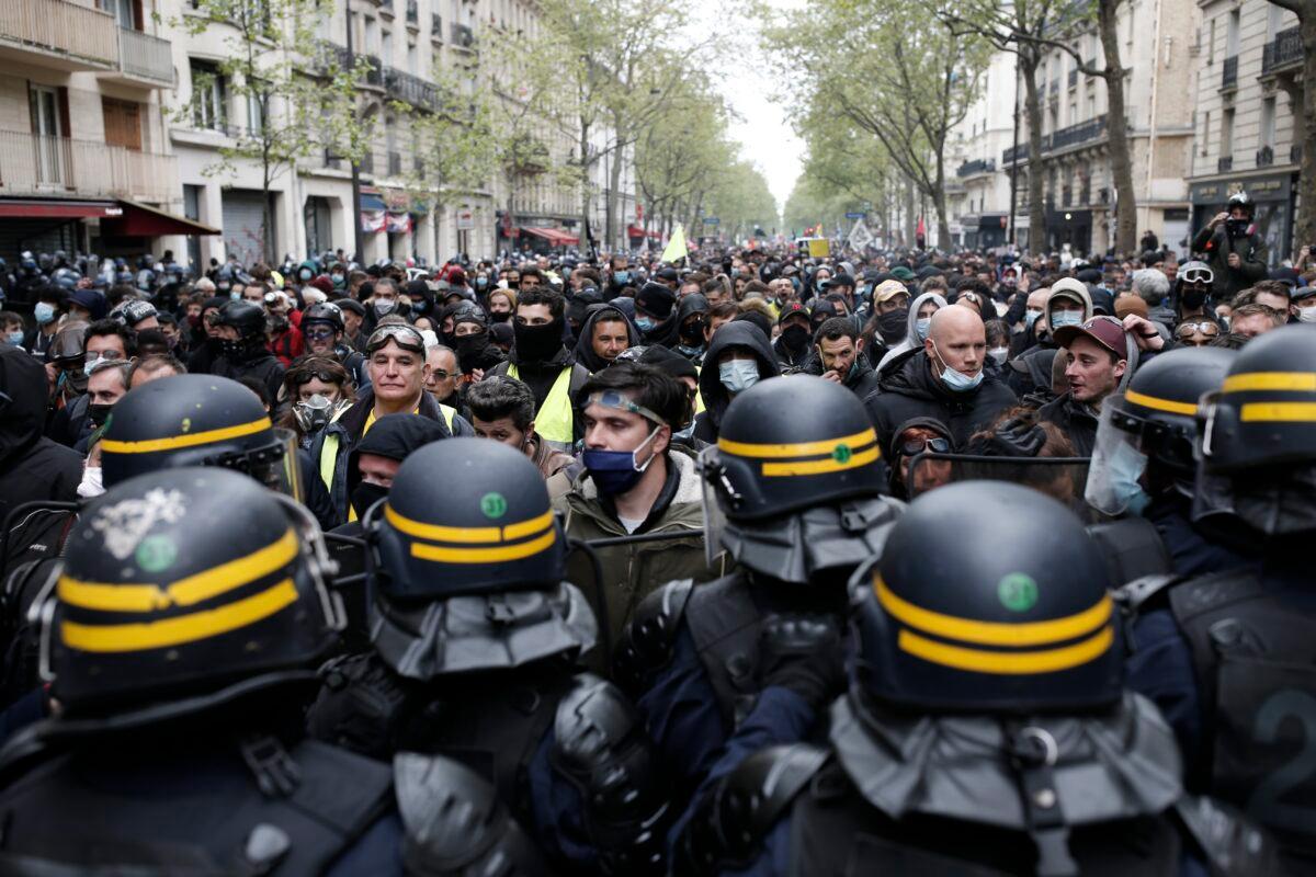 Riot police officers frame demonstrators during the May Day march in Paris, on May 1, 2021. (Lewis Joly/AP Photo)