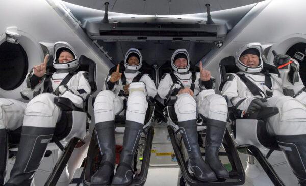 NASA astronauts Shannon Walker (L), Victor Glover, Mike Hopkins, and Japan Aerospace Exploration Agency (JAXA) astronaut Soichi Noguchi (R) are seen inside the SpaceX Crew Dragon Resilience spacecraft onboard the SpaceX GO Navigator recovery ship shortly after having landed in the Gulf of Mexico off the coast of Panama City, Fla., on May 2, 2021. (Bill Ingalls/NASA via AP)