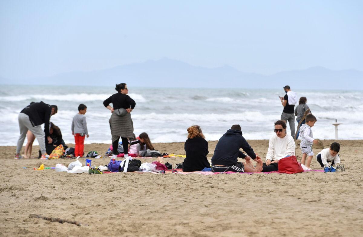People enjoy a Sunday at the beach as COVID-19 restrictions ease around the country, in Castiglione della Pescaia, Italy, on May 2, 2021. (Jennifer Lorenzini/Reuters)