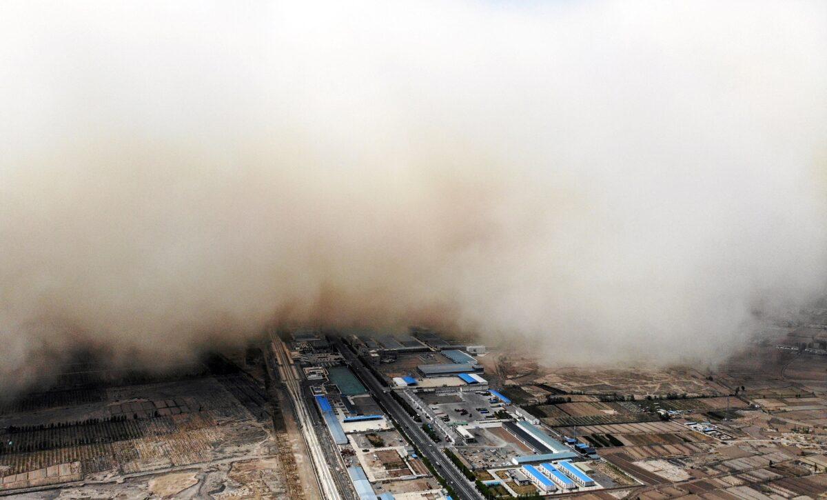A sandstorm is engulfing a village in Linze county, in the city of Zhangye in China's northwestern Gansu Province on April 25, 2021. (STR/CNS/AFP via Getty Images)