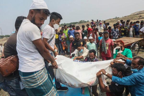 The body of a victim is carried after a speedboat overturned in River Padma at the Kanthalbari ferry terminal in Madaripur, central Bangladesh, on May 3, 2021. (Abdul Goni/AP Photo)
