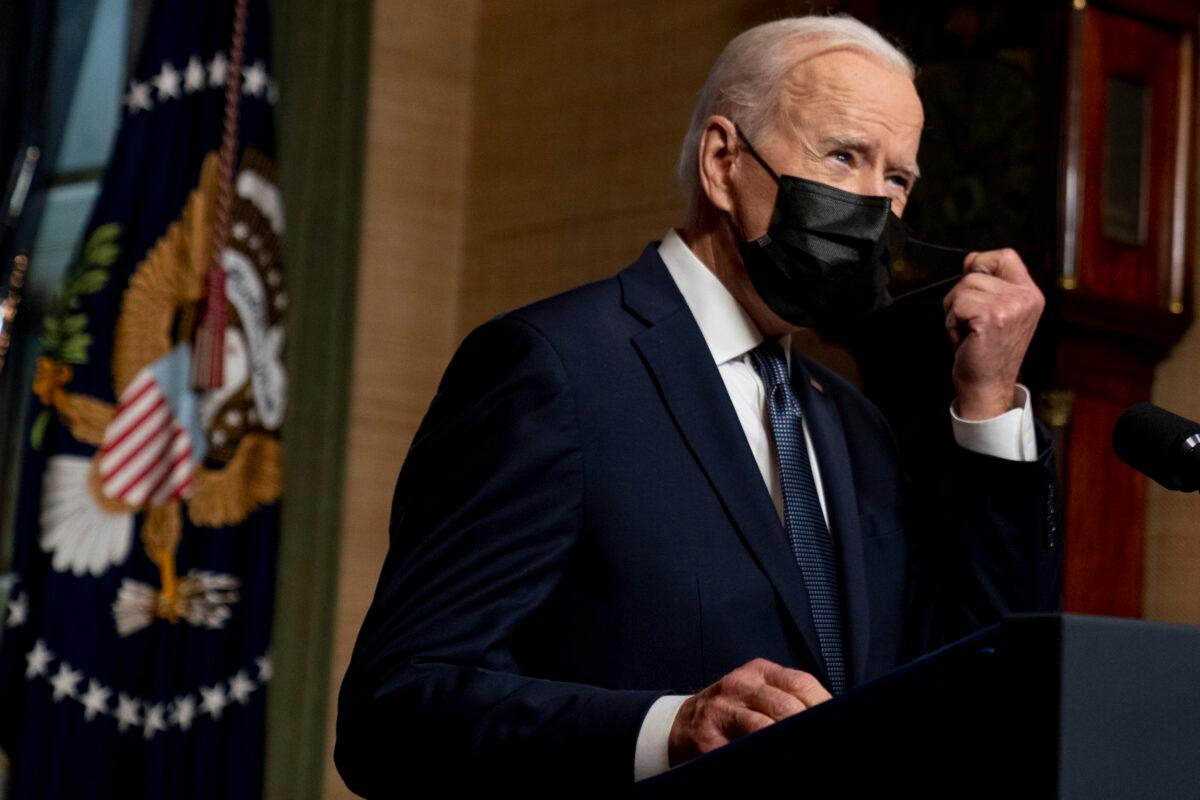 President Joe Biden removes his mask to speak at a news conference at the White House in Washington on April 14, 2021. (AP Photo/Andrew Harnik, Pool, File)