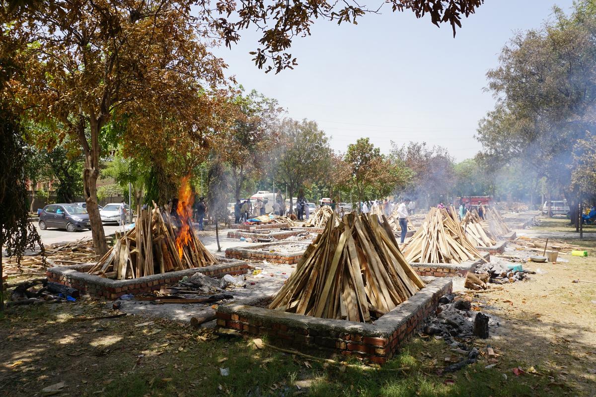 The pyre of 45-year-old Sher Pal Singh, a gazetted officer with India's National Information Center catches fire at the Sarai Kale Khan crematorium on May 4, 2021. Singh, a father of two daughters and one son passed away at the hospital one week after testing positive. (Venus Upadhayaya/The Epoch Times)