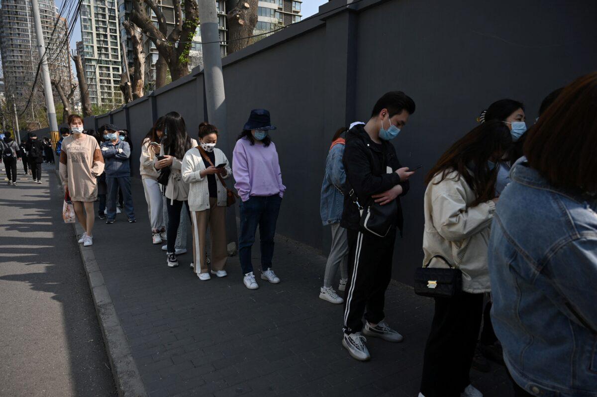 People line up to be vaccinated against the COVID-19 coronavirus, outside a residential compound in Beijing on April 8, 2021. (Leo Ramirez/AFP via Getty Images)