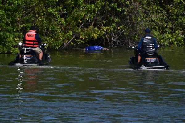 Authorities look at the body of 27-year-old Keishla Rodriguez in the San Jose lagoon after she was reported missing in San Juan, Puerto Rico, on May 1, 2021. (Carlos Giusti/AP Photo)