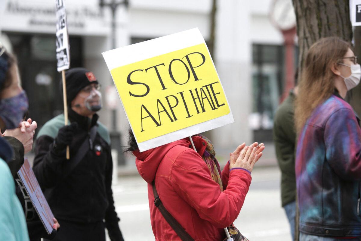 A demonstrator holds a sign calling for a stop to hate against Asian Americans and Pacific Islanders (AAPI) during a national day of action against anti-Asian violence in Seattle, Wash., on March 27, 2021. (Jason Redmond/AFP via Getty Images)