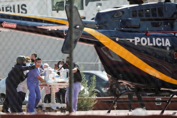 Paramedics transport Brandon Giovani Hernandez who was injured during the accident toward a helicopter, in Mexico City, Mexico, on May 4, 2021. (Luis Cortes/Reuters)