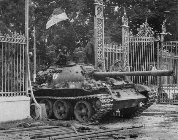 A picture taken on April 30, 1975 in Saigon shows a tank of the North Vietnamese Army (NVA) smashing in the gate of the South Vietnamese presidential palace, South Vietnamese government's last stronghold.  (-/VNA/AFP via Getty Images)