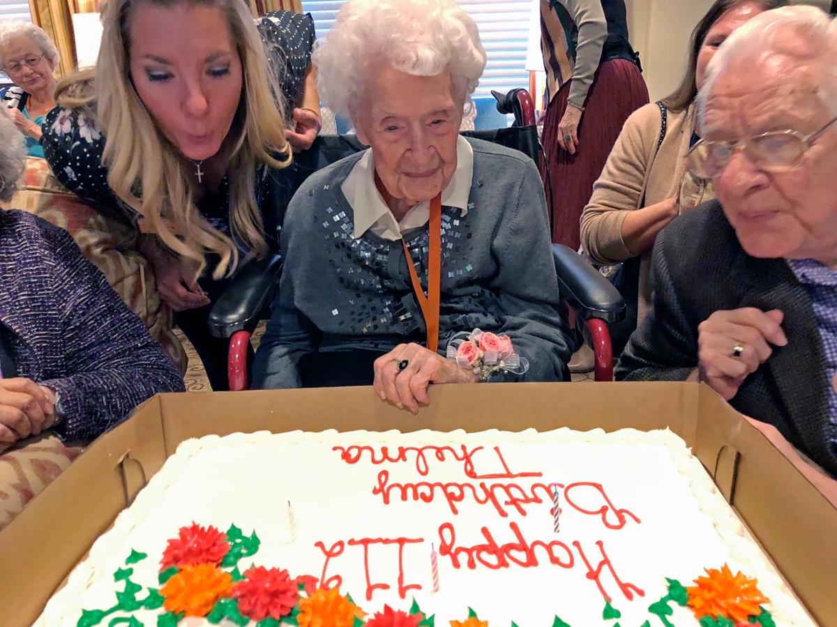 Thelma Sutcliffe is shown with a birthday cake in October 2019, in Omaha, Nebraska. Sutcliffe is now the oldest living American at 114 years old. (Mike Kelly/The World-Herald via AP)