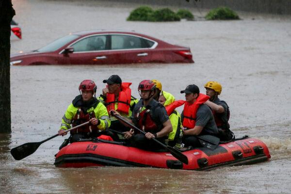 Residents of the Crescent at Lakeshore apartment complex are rescued by Homewood Fire and Rescue as severe weather produced torrential rainfall flooding several apartment buildings in Homewood, Ala., on May 4, 2021. (Butch Dill/AP Photo)