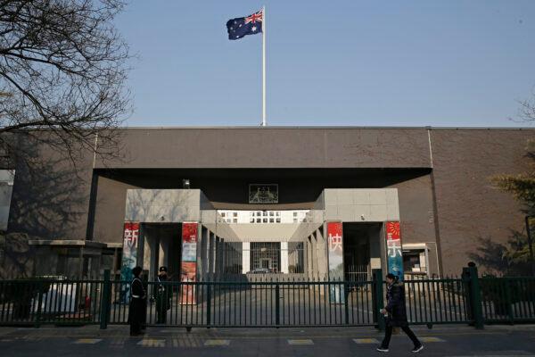 A woman walks by the Australian Embassy in Beijing, China, on Jan. 24, 2019. (Andy Wong/AP Photo)
