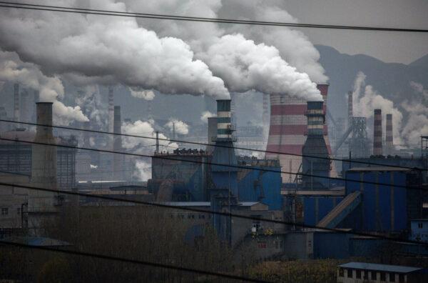 Smoke billows from smokestacks and a coal-fired generator at a steel factory in China's Hebei Province, on Nov. 19, 2015. (Kevin Frayer/Getty Images)