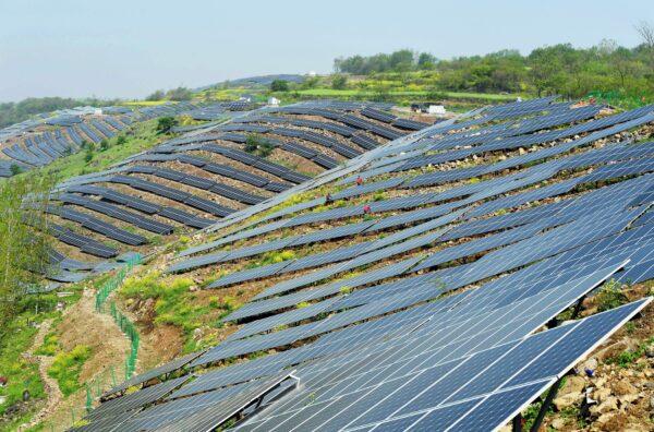 Chinese workers check solar photovoltaic modules on a hillside in a village in Chuzhou, in eastern China's Anhui Province on April 13, 2017. Solar panels, which convert sunlight into electricity, are a key player in the fast-growing renewable energy sector, which also includes water- and wind-generated electricity. Unlike energy from fossil fuels such as oil, coal and gas, the generation of electricity by so-called photovoltaic (PV) panels does not release planet-harming carbon dioxide. (STR/AFP via Getty Images)