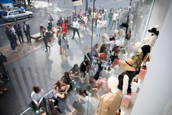 People wait in line on Queen Street before the opening of New Zealand's first TopShop and TopMan store on March 12, 2015 in Auckland, New Zealand. (Phil Walter/Getty Images)