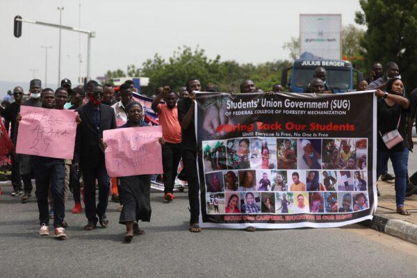 Parents and relatives of students from the Federal College of Forestry Mechanization in Kaduna who have been abducted hold banners and placards during a demonstration in Abuja to demand the release of their families who have spent 55 days in captivity, in Nigeria on May 4, 2021. (Kola Sulaimon/AFP via Getty Images)