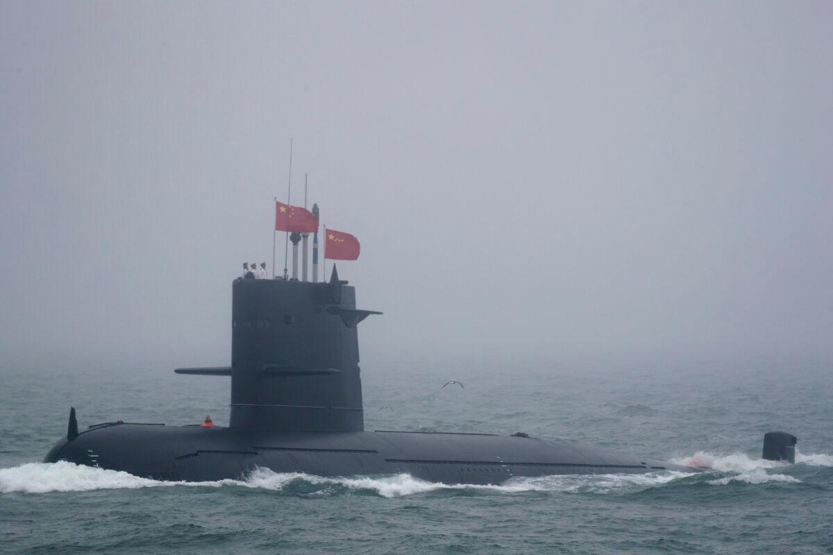A Great Wall 236 submarine of the Chinese People's Liberation Army Navy (PLAN), billed by Chinese state media as a new type of conventional submarine, participates in a naval parade to commemorate the 70th anniversary of the founding of China's PLA Navy in the sea near Qingdao, in eastern China's Shandong Province on April 23, 2019. (Mark Schiefelbein/Pool/AFP)