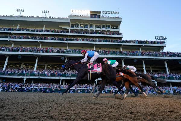 John Velazquez riding Medina Spirit leads Florent Geroux on Mandaloun and Flavien Prat riding Hot Rod Charlie to win the 147th running of the Kentucky Derby at Churchill Downs in Louisville, Ky., on May 1, 2021. (Jeff Roberson/AP Photo)