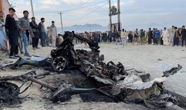 People stand at the site of a blast in Kabul, Afghanistan, on May 8, 2021. (Stringer/Reuters)