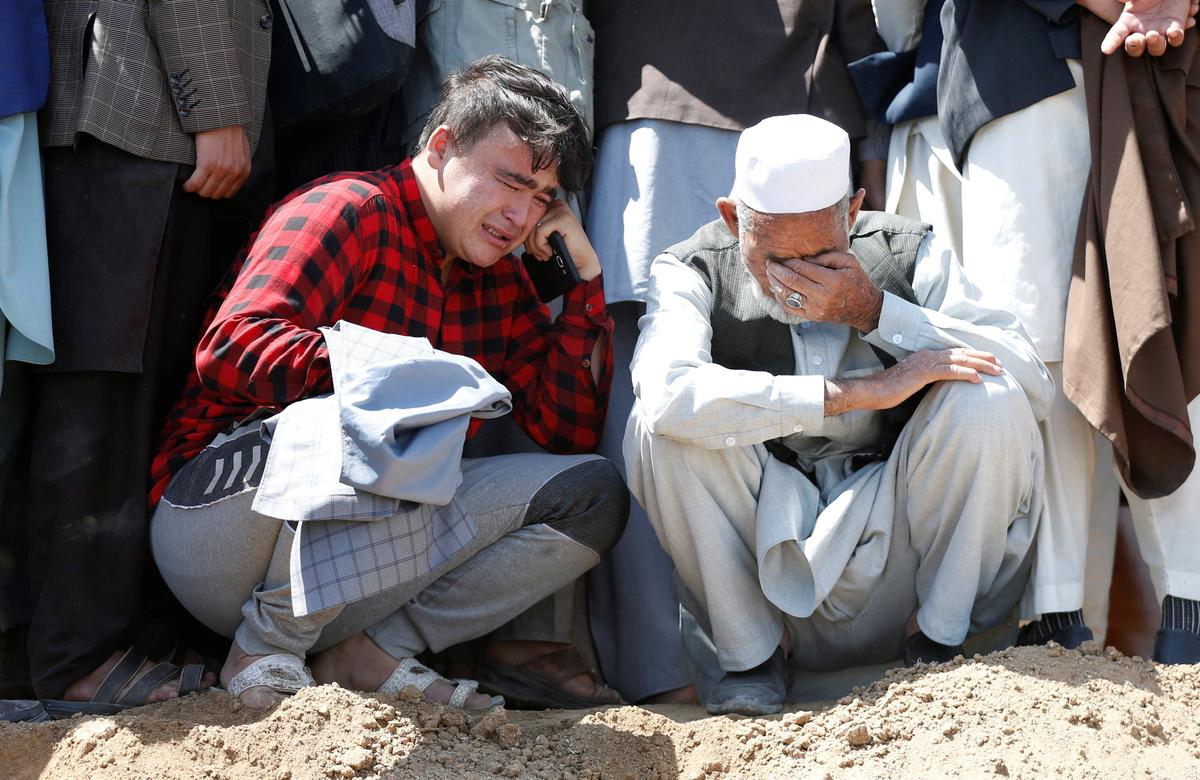 Relatives mourn the victims of May 8 explosion during a mass funeral ceremony in Kabul, Afghanistan, on May 9, 2021. (Stringer/Reuters)