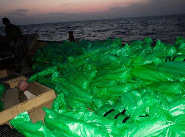 Plastic-wrapped weapons are seen on the deck of a stateless dhow that the U.S. Navy said carried a hidden arms shipment in the Arabian Sea, on May 7, 2021. (U.S. Navy via AP)