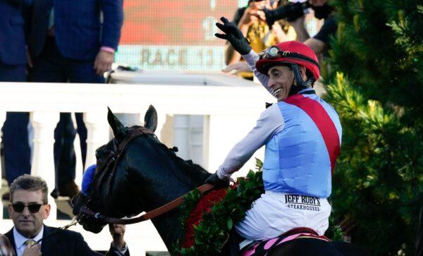 John Velazquez riding Medina Spirit throws a rose after his victory in the 147th running of the Kentucky Derby at Churchill Downs, in Louisville, Ky., on May 1, 2021. (Jeff Roberson/AP Photo)